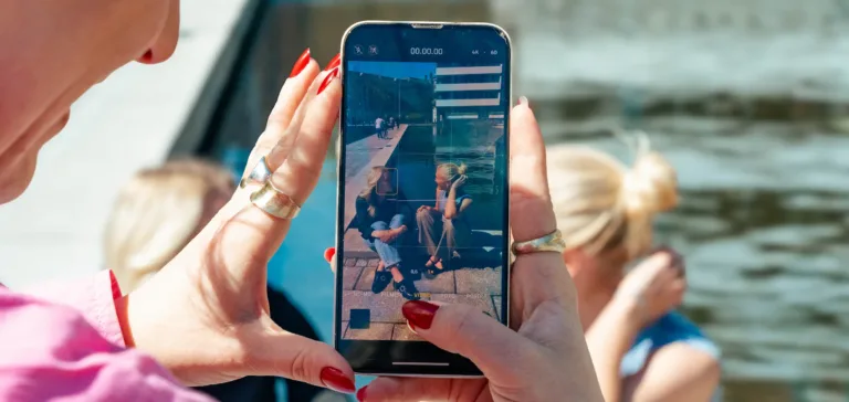 En kvinde der tager billede af to andre kvinder udenfor